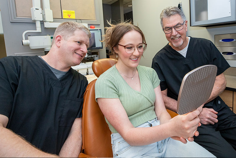 Patient smiling confidentyl after their dental procedure